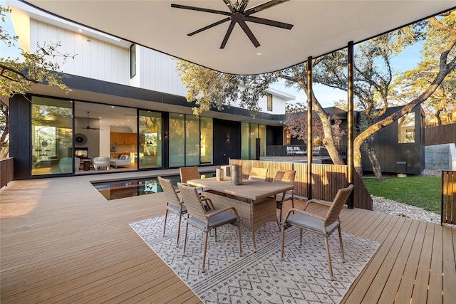 wooden deck with ceiling fan and outdoor dining space