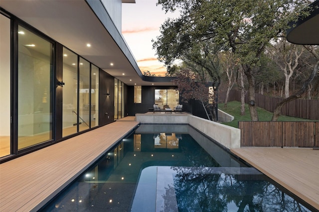 view of pool at dusk