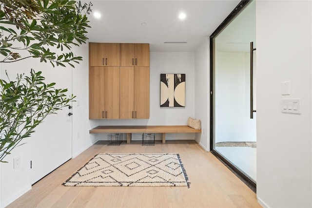 mudroom with light wood-style floors and baseboards