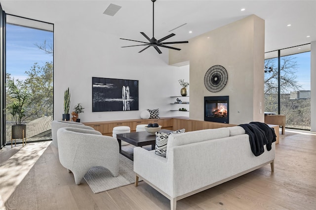 living room featuring light hardwood / wood-style floors, a healthy amount of sunlight, and floor to ceiling windows