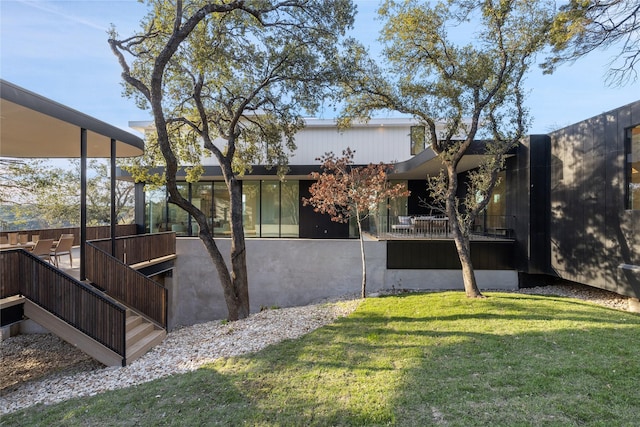 view of side of home with a lawn