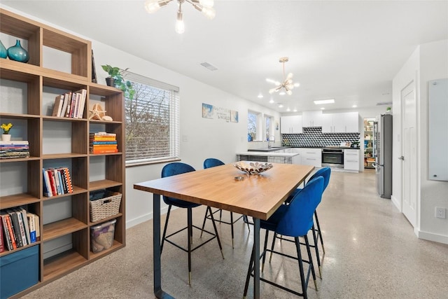 dining area featuring an inviting chandelier