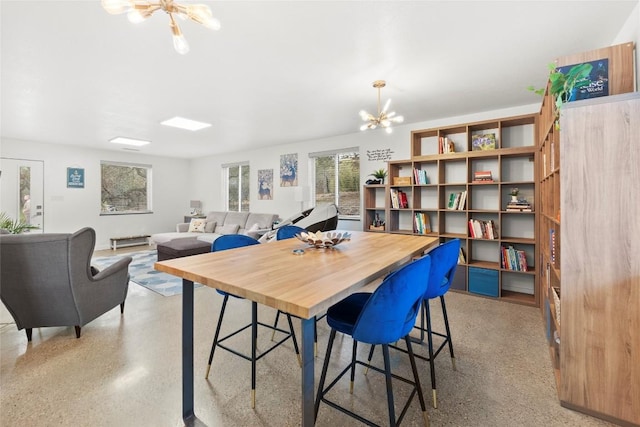 dining space featuring a notable chandelier