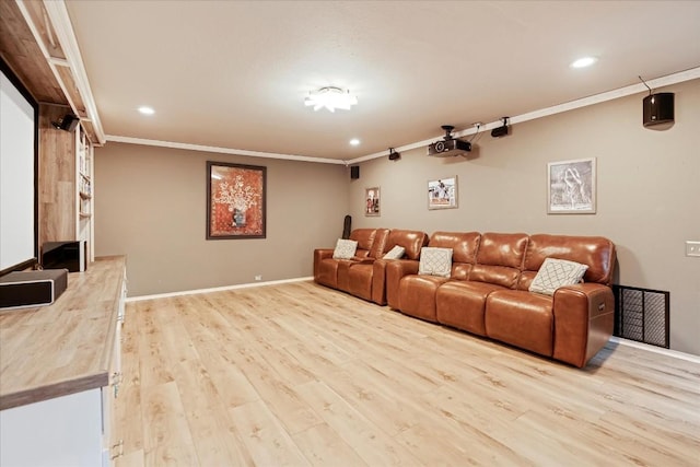 home theater room with crown molding and light hardwood / wood-style flooring