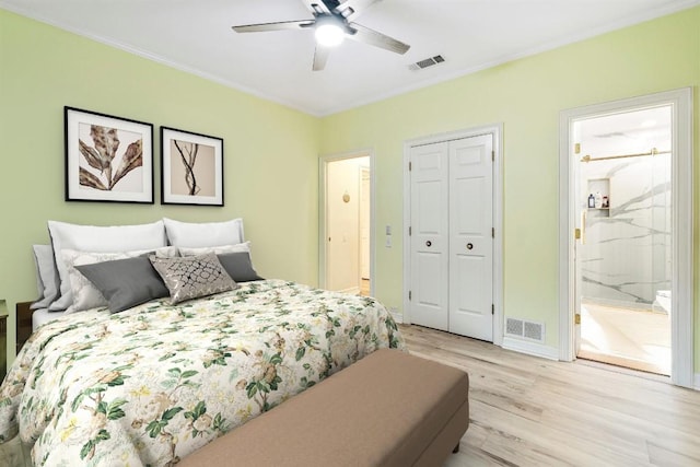 bedroom with ensuite bathroom, light hardwood / wood-style flooring, and ceiling fan