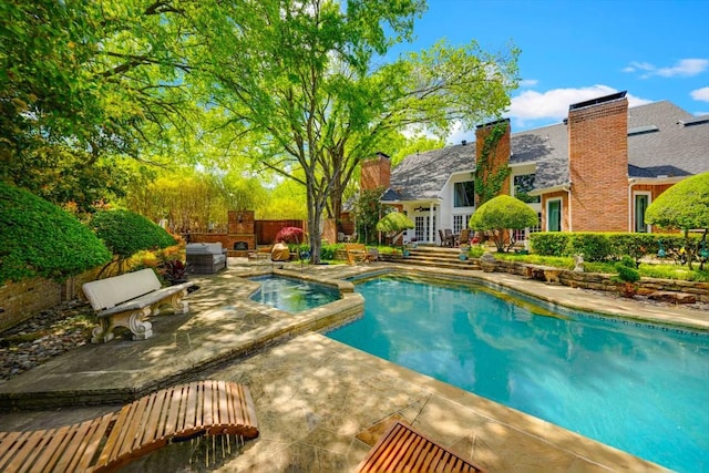 view of swimming pool featuring a patio area and french doors