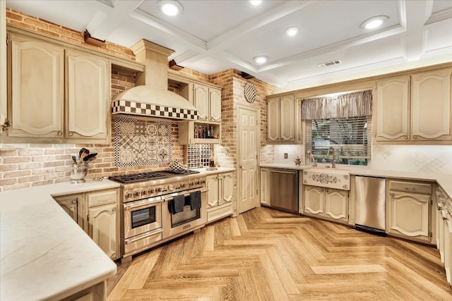 kitchen featuring custom exhaust hood, decorative backsplash, sink, and appliances with stainless steel finishes