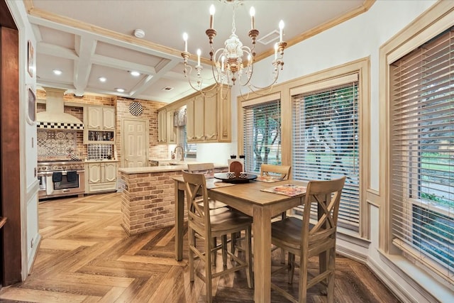 dining room with ornamental molding, coffered ceiling, sink, an inviting chandelier, and beamed ceiling