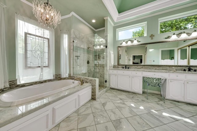 bathroom featuring a notable chandelier, plenty of natural light, shower with separate bathtub, and vanity