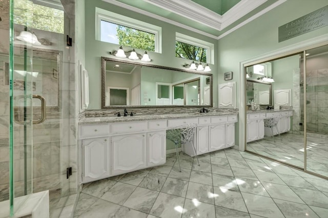 bathroom with a shower with shower door, a towering ceiling, and vanity