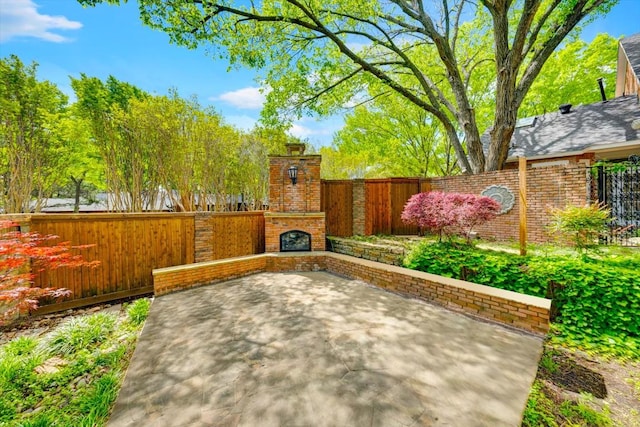 view of patio with an outdoor stone fireplace