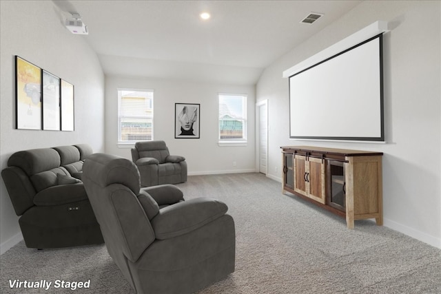 home theater featuring light carpet and vaulted ceiling