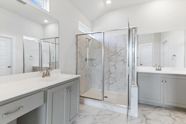 bathroom with a shower with shower door, lofted ceiling, and vanity