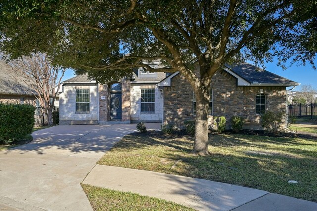 view of property hidden behind natural elements with a front yard