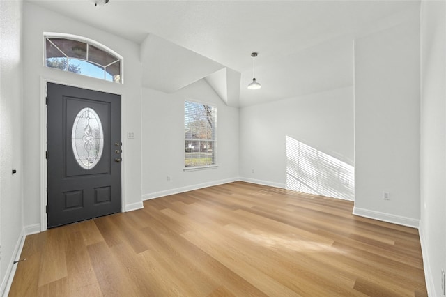 entrance foyer featuring light hardwood / wood-style flooring and vaulted ceiling