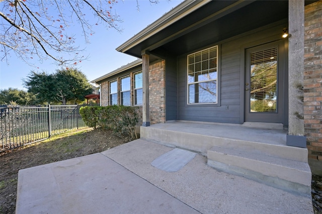 view of exterior entry featuring a patio