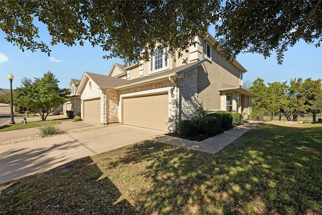 view of front of home with a garage and a front lawn