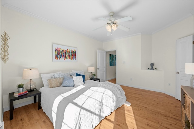 bedroom with ceiling fan, ornamental molding, and light hardwood / wood-style flooring