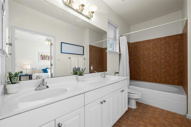 full bathroom with tile patterned floors, vanity, shower / tub combo with curtain, ceiling fan, and toilet