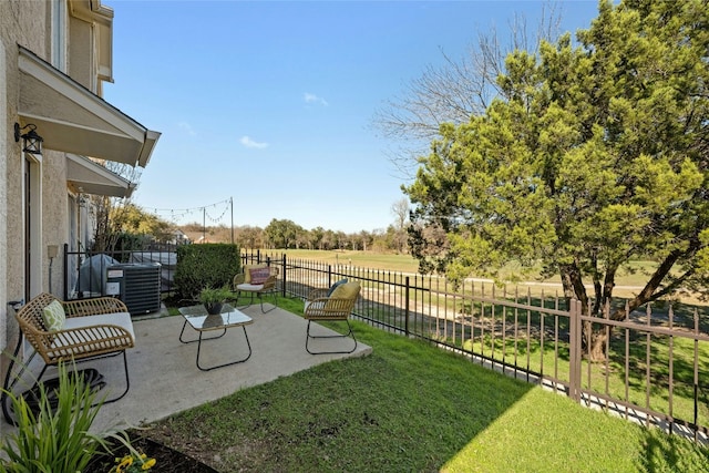 view of yard featuring a rural view, central air condition unit, and a patio