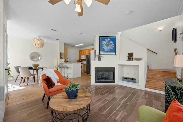 living room featuring hardwood / wood-style flooring and ceiling fan