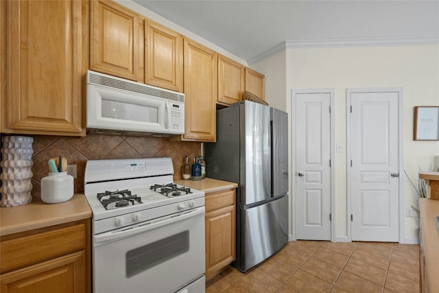 kitchen with light tile patterned flooring, white appliances, crown molding, and tasteful backsplash