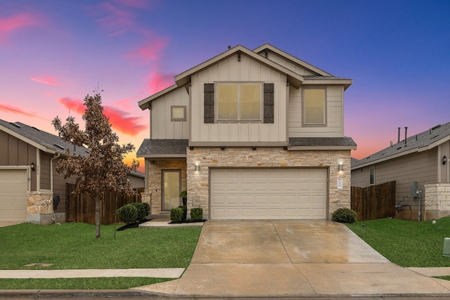 view of front of property with a garage and a yard