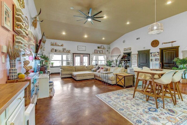 living room featuring vaulted ceiling and ceiling fan