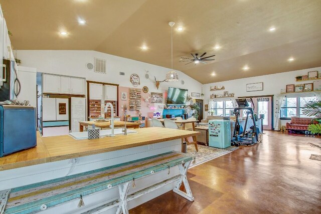 dining area with vaulted ceiling, ceiling fan, and sink