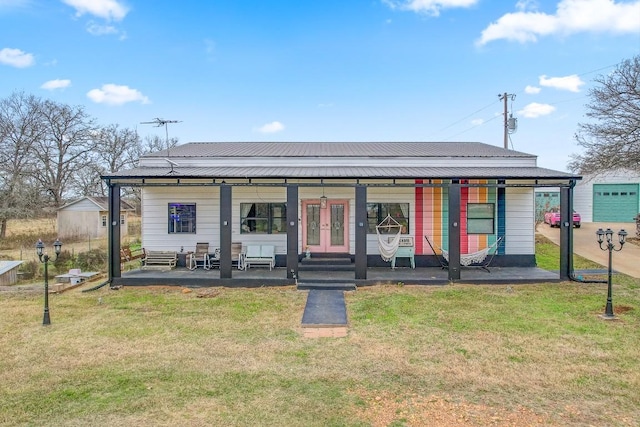 view of front of property with french doors, a porch, and a front yard