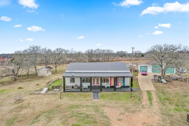 view of front of house with a storage unit and a porch