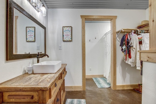 bathroom with vanity and concrete flooring