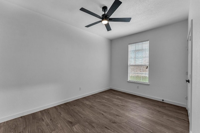 spare room featuring ceiling fan and dark hardwood / wood-style flooring