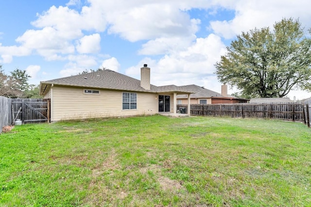 back of property featuring a lawn