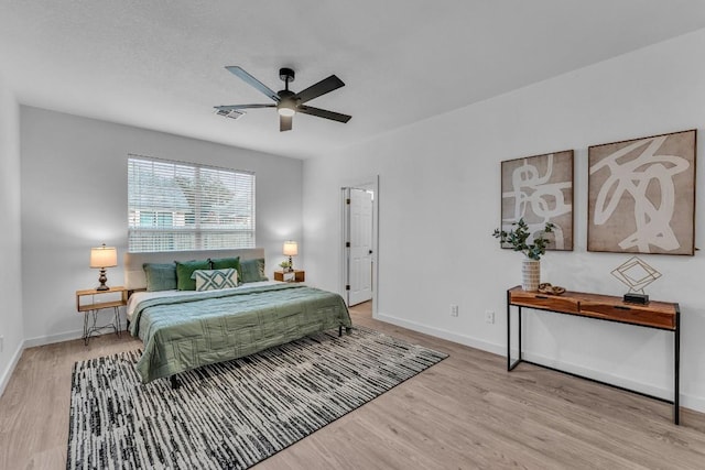 bedroom with ceiling fan and light hardwood / wood-style floors