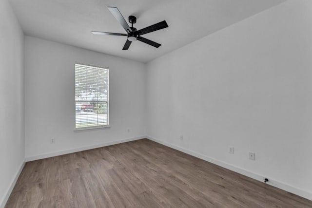 empty room featuring ceiling fan and wood-type flooring