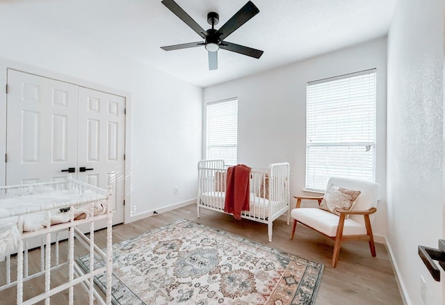 177 Oxford Dr, Kyle, TX 78640 - bedroom with wood finished floors, baseboards, a closet, and ceiling fan