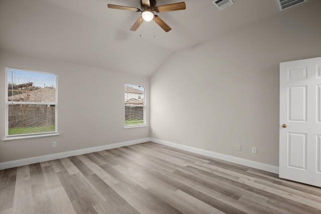 spare room featuring ceiling fan, plenty of natural light, light hardwood / wood-style floors, and vaulted ceiling