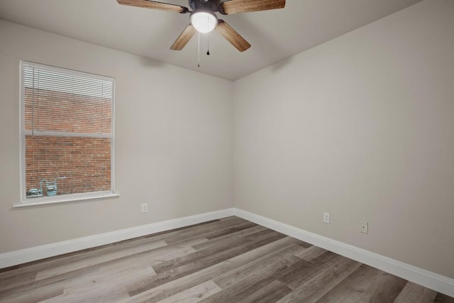 empty room featuring ceiling fan, a healthy amount of sunlight, and light wood-type flooring