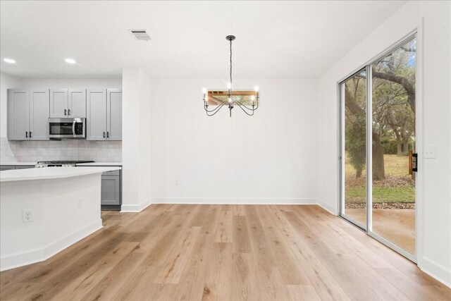 151 Dan Moody Trl, Georgetown, TX 78633 - unfurnished dining area with light wood-style flooring, a chandelier, and recessed lighting
