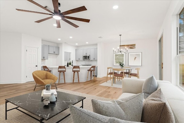 151 Dan Moody Trl, Georgetown, TX 78633 - living room with light wood-type flooring, ceiling fan, recessed lighting, and a chandelier