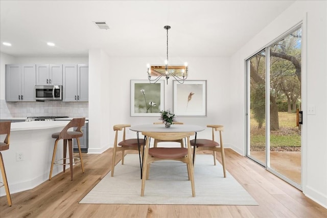 151 Dan Moody Trl, Georgetown, TX 78633 - dining area featuring light wood-style flooring, a chandelier, and recessed lighting