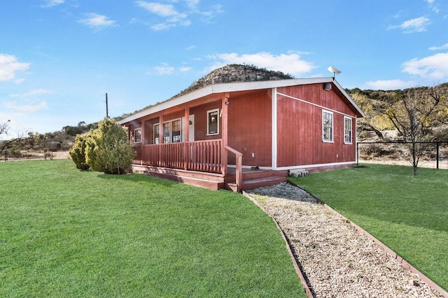 view of property exterior with a yard and covered porch