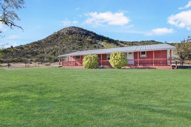 view of front of house with a mountain view and a front lawn