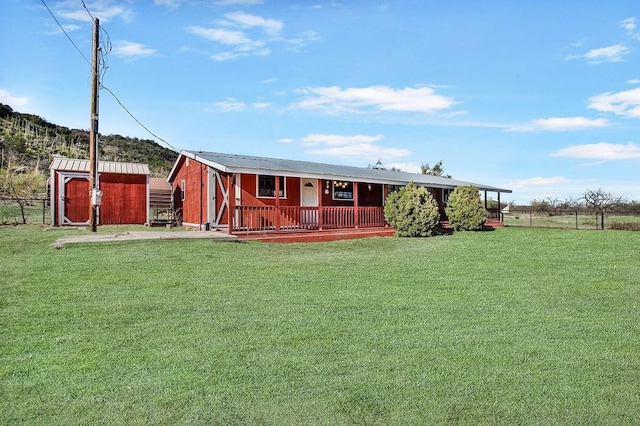 exterior space with a front lawn and a storage unit