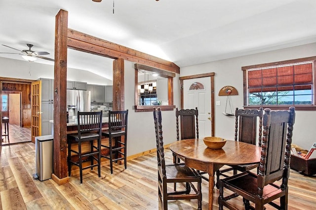 dining space with light hardwood / wood-style flooring, vaulted ceiling, and ceiling fan