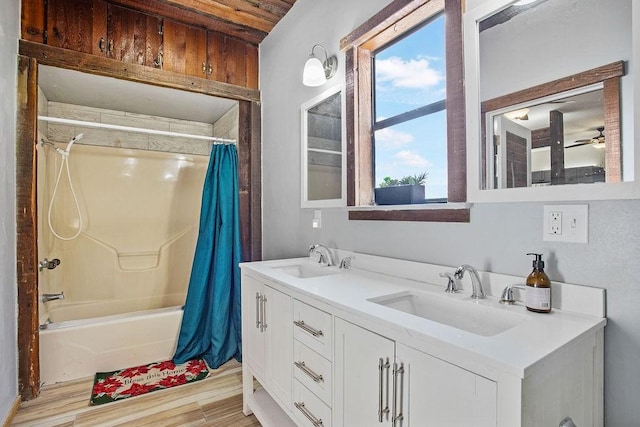 bathroom featuring shower / bath combo with shower curtain, plenty of natural light, vanity, and hardwood / wood-style floors