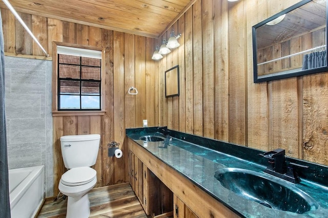 bathroom with hardwood / wood-style floors, vanity, wooden walls, toilet, and wood ceiling