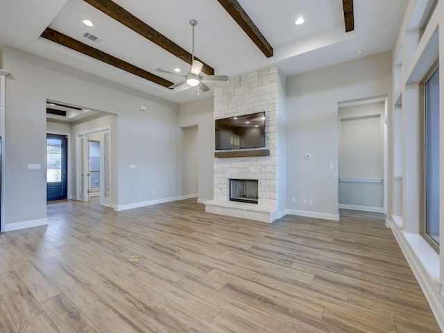 19516 Tranquility Falls Path, Lago Vista, TX 78645 - unfurnished living room featuring a ceiling fan, a stone fireplace, light wood-type flooring, beam ceiling, and recessed lighting
