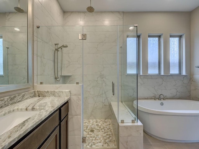 bathroom with vanity, tile patterned flooring, plus walk in shower, and tile walls